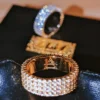 Gold-plated zirconia eternity bands with Almighty logo detail in bokeh lighting