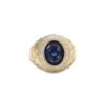 Gold ring with oval blue sapphire center, double diamond halo, and engraved band detail on white background