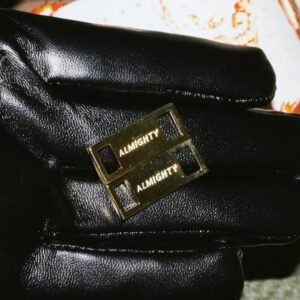 Gold sneaker crown attachments showing Almighty branding on black leather