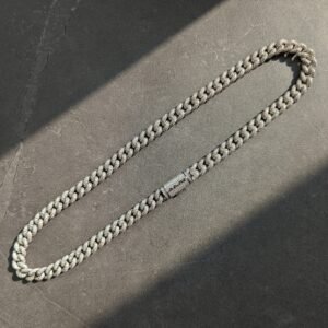 White gold 10mm bubble-style cuban link chain on textured dark surface with dramatic lighting