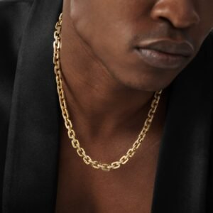 Chunky gold-tone chain link necklace worn with black blazer