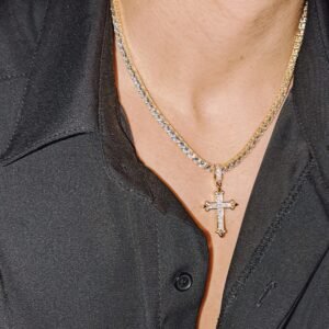 Gold plated cross pendant with crystal detail on matching tennis chain necklace worn with black shirt