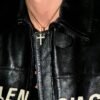 Gold plated cross pendant with diamond accents on chain, worn with black leather jacket