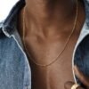 Gold dog bone link chain necklace styled with denim shirt