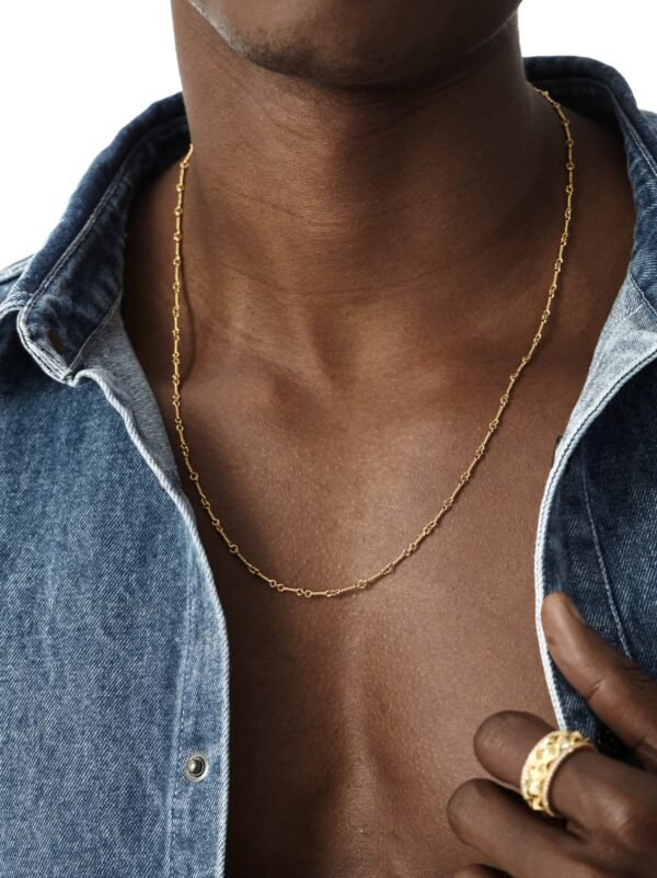 Gold dog bone link chain necklace styled with denim shirt