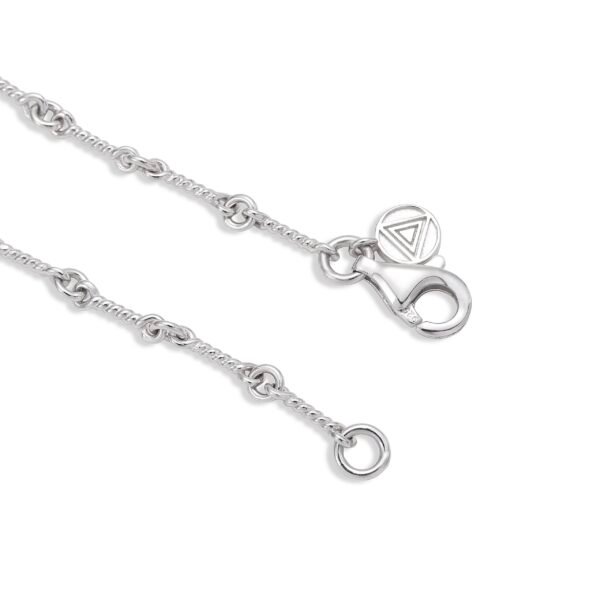 Close-up of white gold dog bone link chain showing clasp and triangle logo tag detail