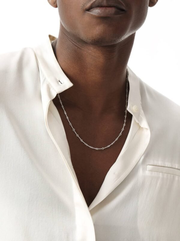 White gold dog bone link chain necklace styled with white dress shirt