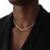 Two-tone metal chain necklace worn with black blazer