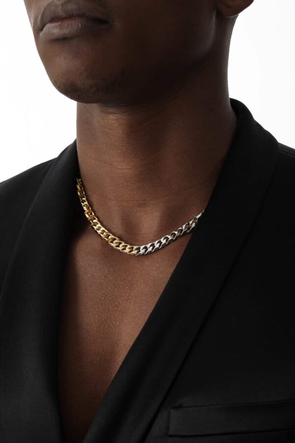 Two-tone metal chain necklace worn with black blazer