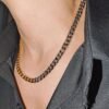 Two-tone curb chain necklace styled with black blazer