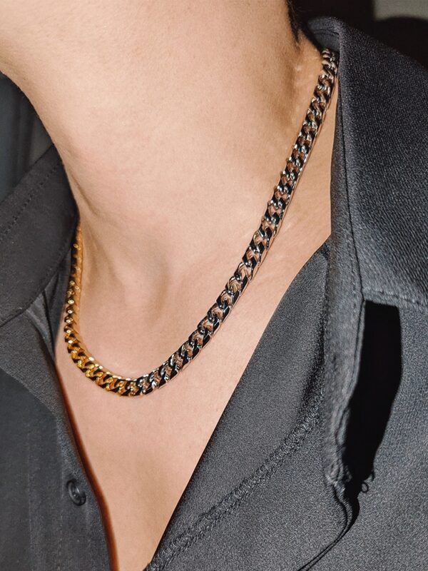 Two-tone curb chain necklace styled with black blazer