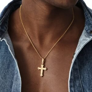 Gold plated cross pendant on fine chain necklace styled with denim jacket