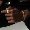 Gold-plated Cuban bracelet and eternity band on dark skin tone Filename: gold-cuban-set-styling