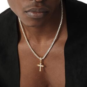 Gold cross pendant on tennis chain styled with black blazer