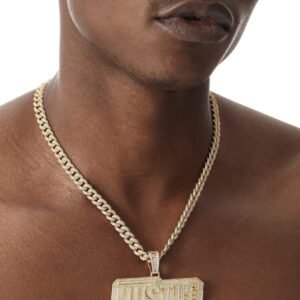 Model wearing gold HUSTLE pendant with matching cubic zirconia Cuban chain and bracelet set