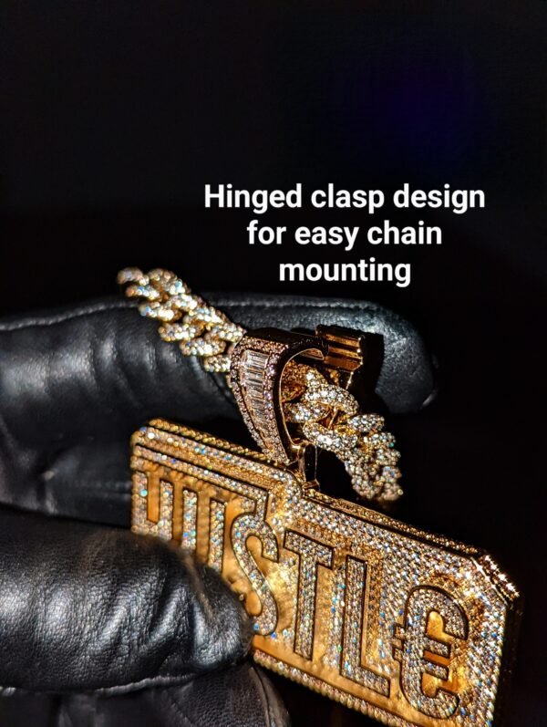 Gold HUSTLE pendant with diamond-studded design featuring innovative hinged clasp mounting system