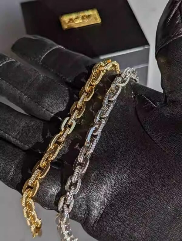 Gold and silver pavé gridlock bracelets on black leather display