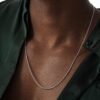 Close-up of white gold round box chain necklace with green shirt styling