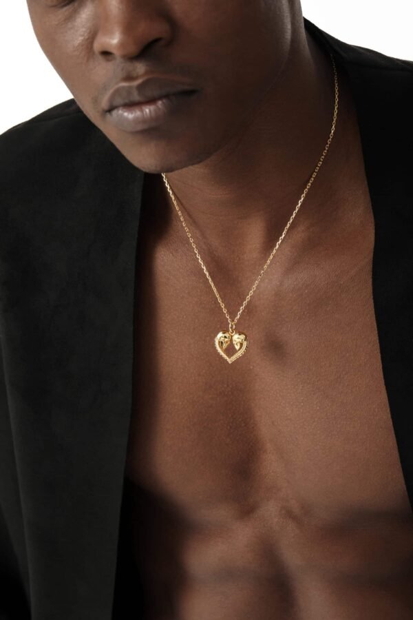 Gold plated skull heart pendant on fine chain necklace with black blazer styling