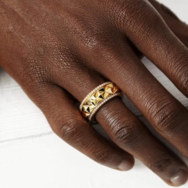 Gold pyramid studded ring with diamond borders worn on dark skin
