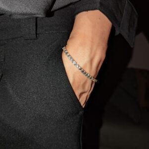 Gold plated tennis bracelet styled with black suit pocket detail