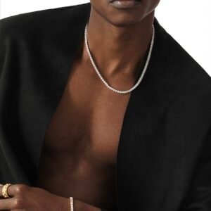 Model wearing white gold tennis chain and matching bracelet with black blazer