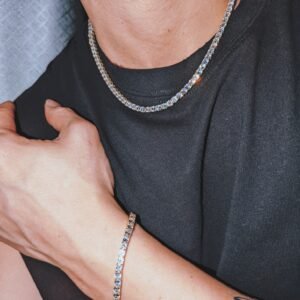 Coordinated tennis necklace and bracelet in silver and gold plating worn with black t-shirt