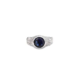 Silver tiger ring with deep blue sapphire center stone shown face-forward on white background