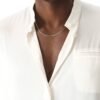 White gold cable link chain on model wearing crisp white shirt