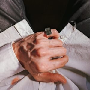 White gold square signet ring worn with crisp white dress shirt and black formal wear